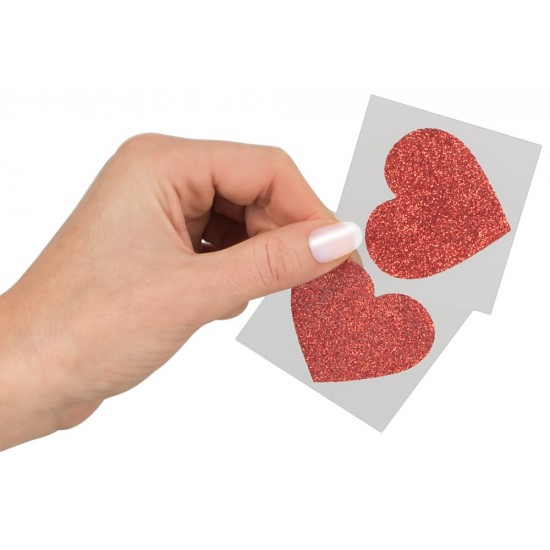 Glitter nipple stickers to add a professional look to private performances. Sparkling red heart-shaped nipple stickers. Size: 5.9 x 5.9 cm. Material: 80% paper, 15% PET, 5% glue. 1 pair.